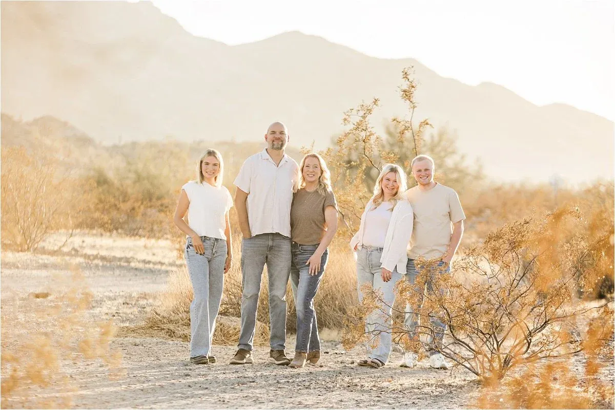 Family of five standing in golden desert light at South Mountain