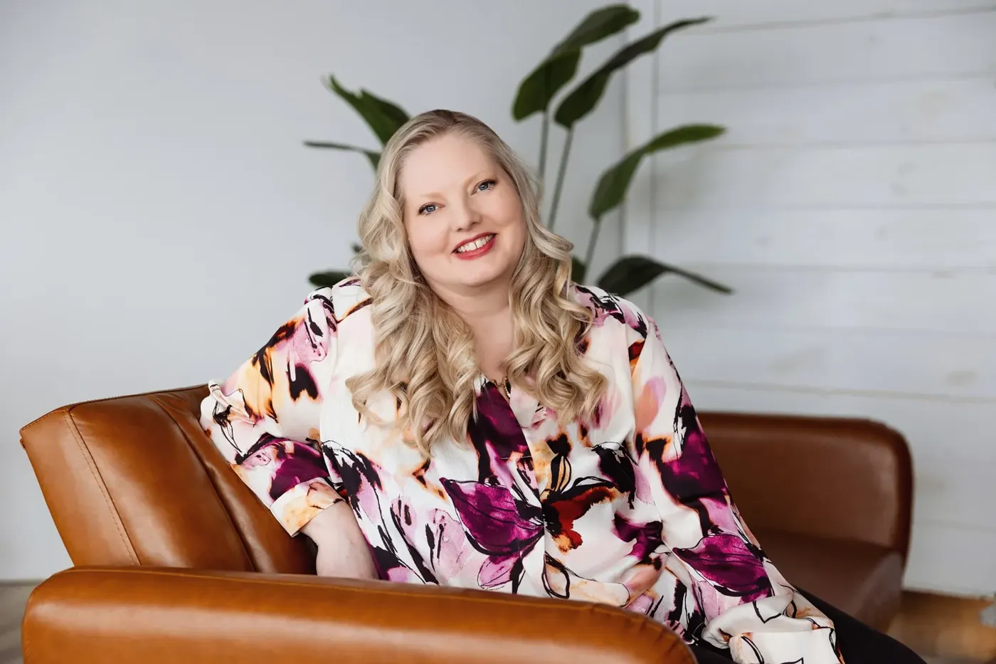 East Valley realtor seated on a leather chair during a mini brand session