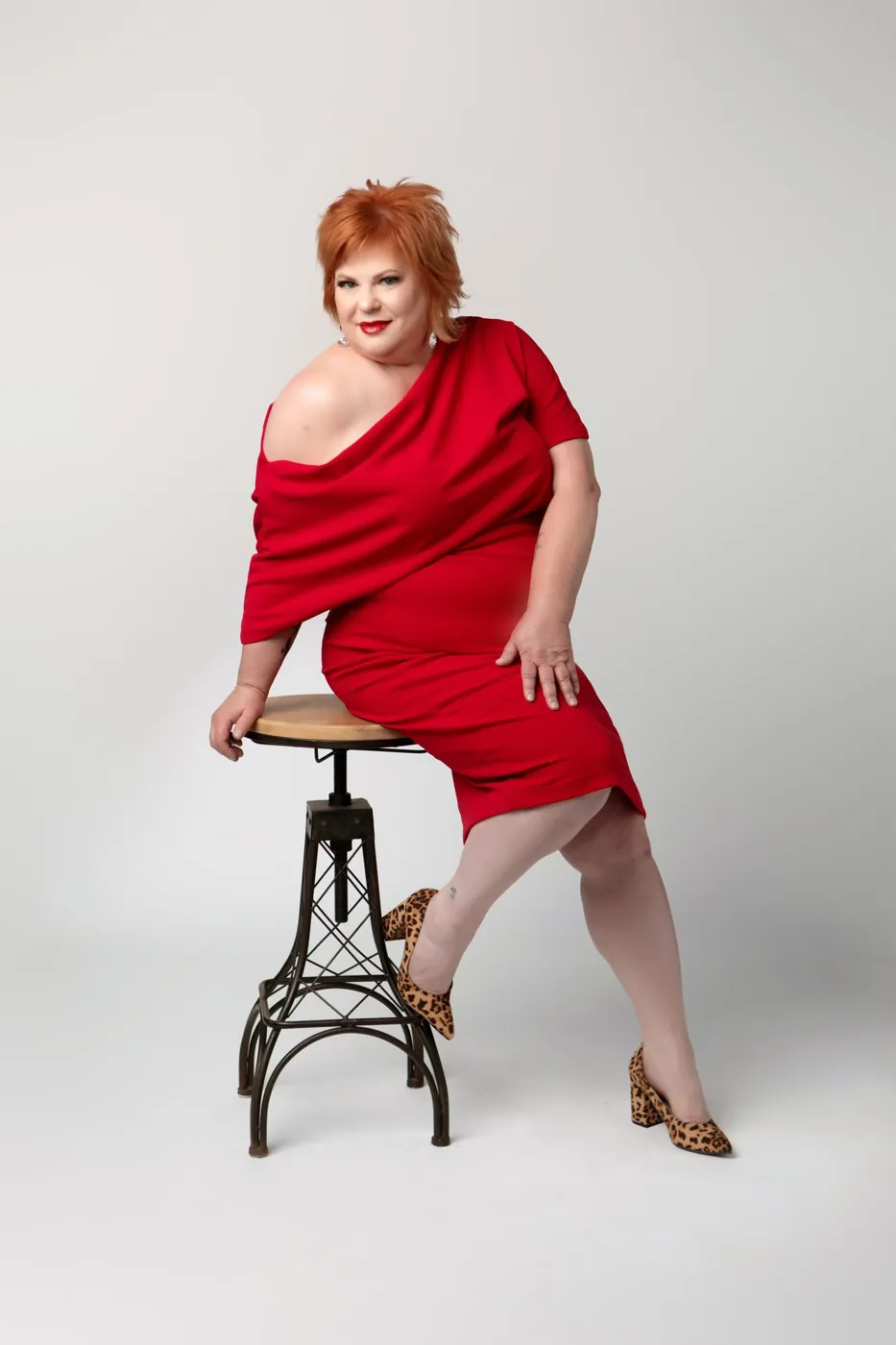 Bold personal branding portrait in a red dress